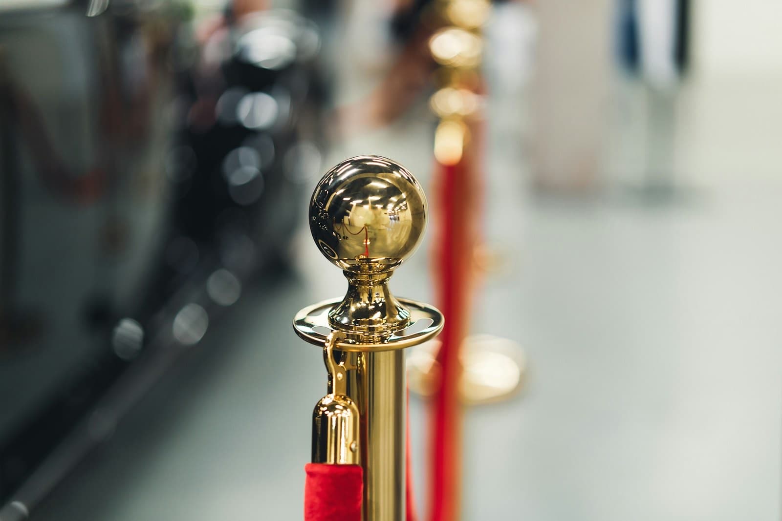 Gold stanchion and red velvet rope at an exclusive entrance