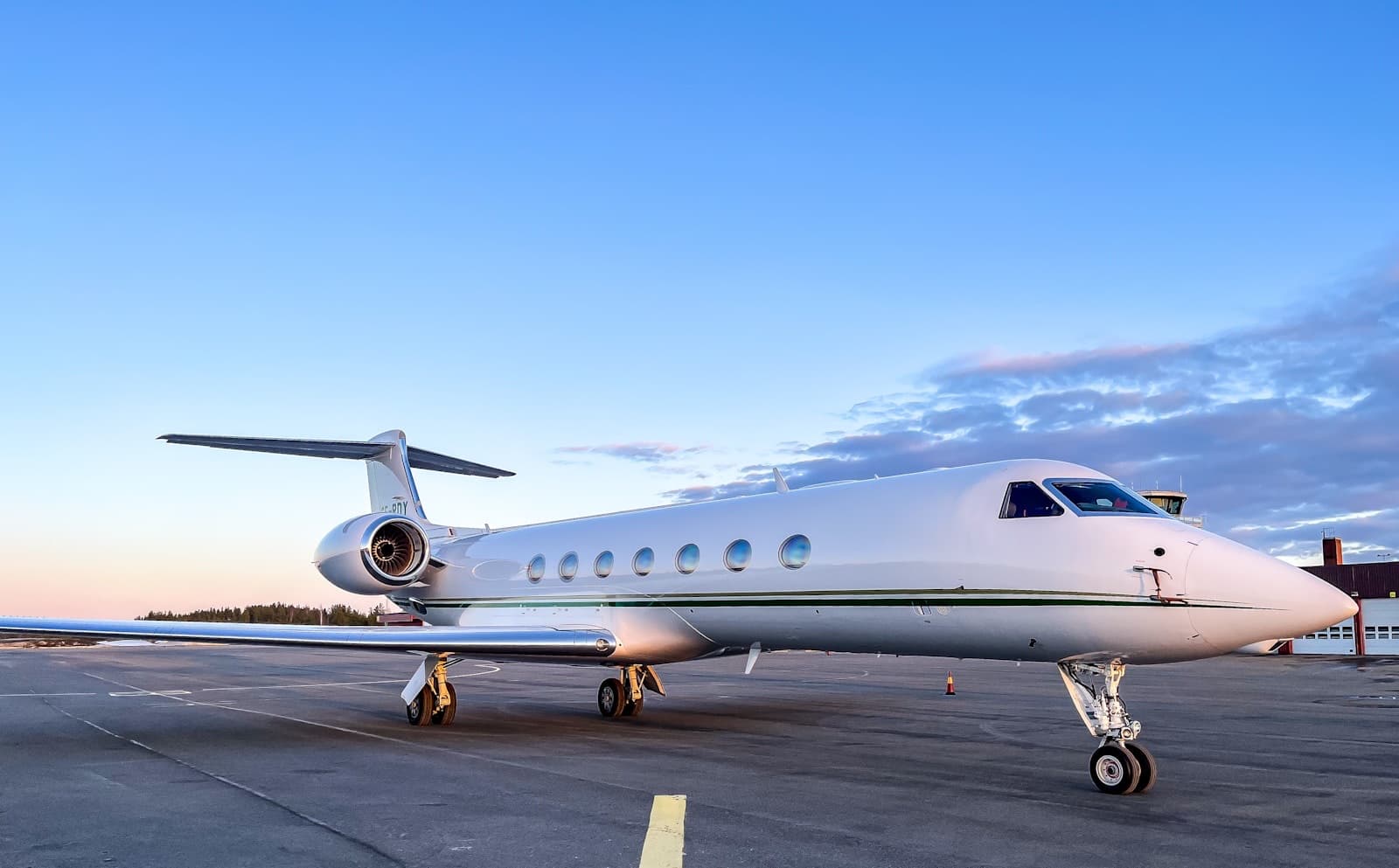 Modern private jet on the tarmac at dusk